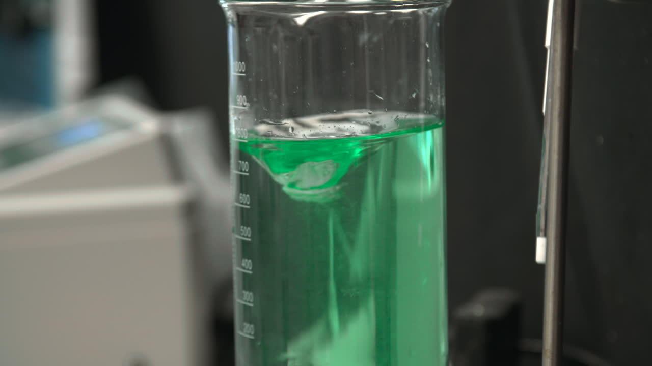 Green Liquid Stirring in a Scientific Laboratory Beaker