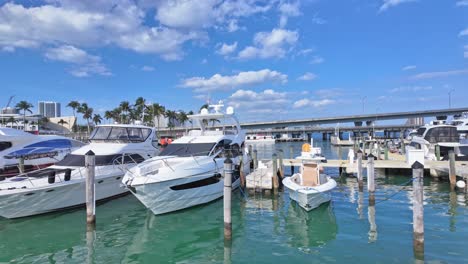 sideways aerial view of docked boats in miami marine port on a sunny summer day