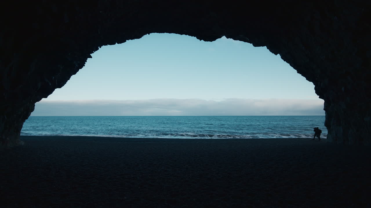 Couple Silhouetted on Black Sand Beach in Iceland