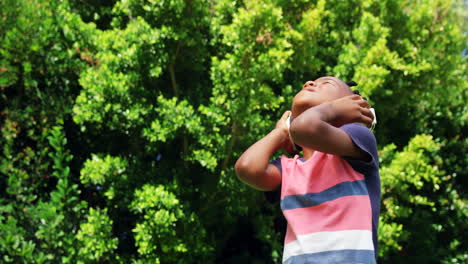 little boy listening music with his headphones