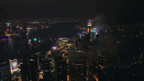 beautifully colored fireworks are set off in the new year fireworks display from the tall buildings of hong kong's skyline