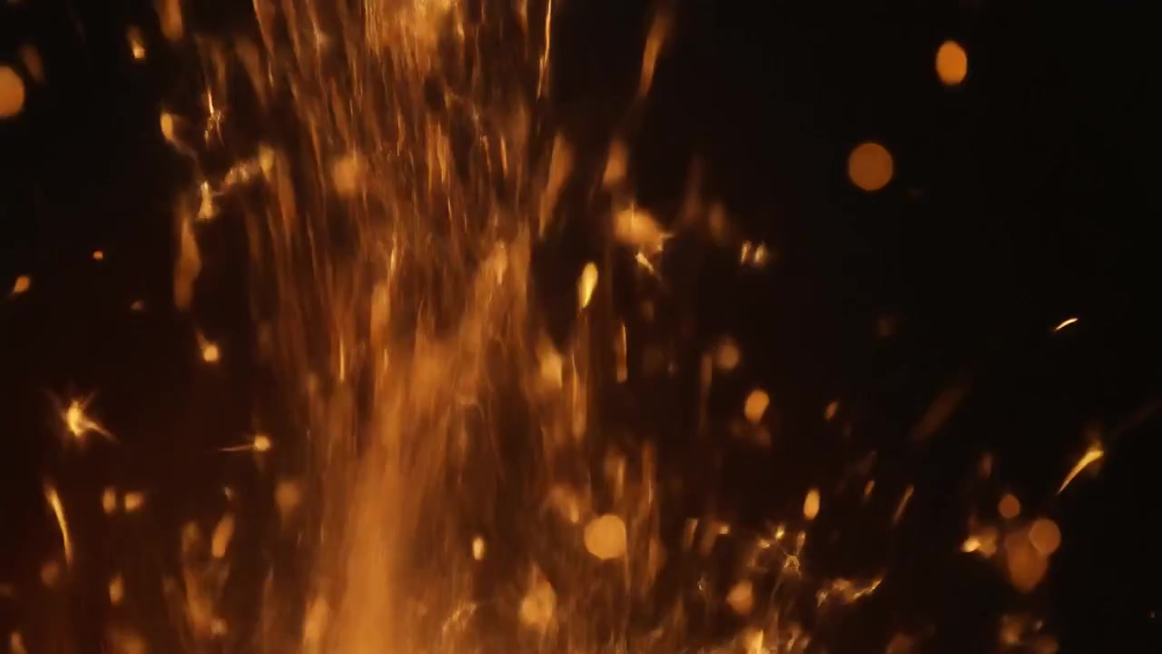 Bright Orange Sparks Rising Against a Dark Background