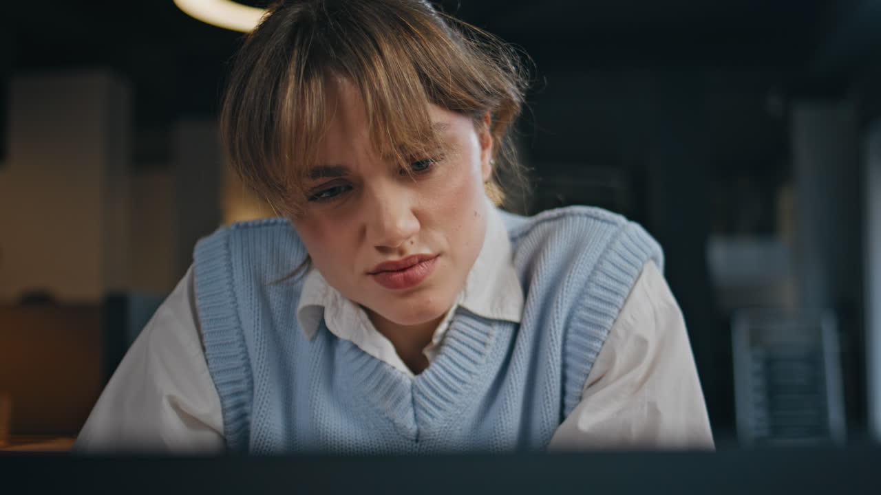 Closeup focused businesswoman reading email at office. Woman looking laptop