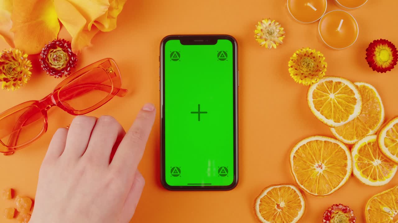 Smartphone with Green Screen on an Orange Background