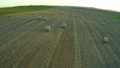 an aerial over bales of hay in a farm field in the midwest 1