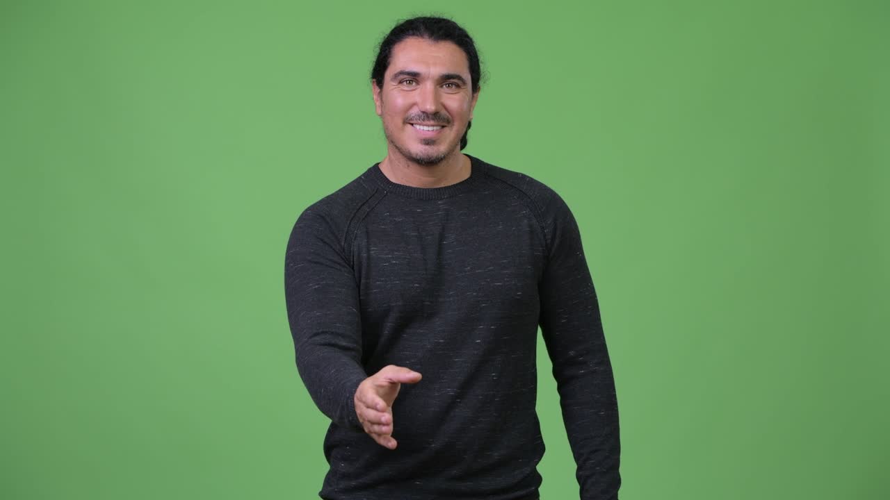 Handsome man smiling and giving handshake