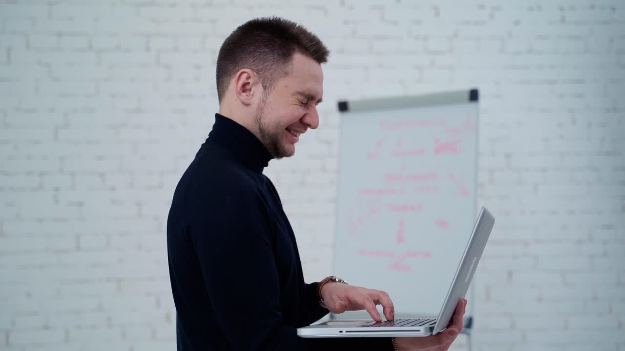 Man standing with laptop. Standing businessman using laptop