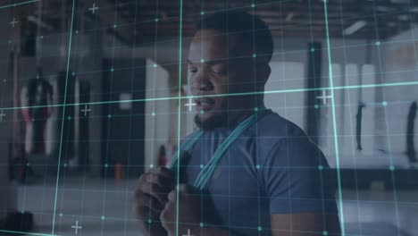 animation of grid pattern, tired african american man with skipping rope around neck standing in gym