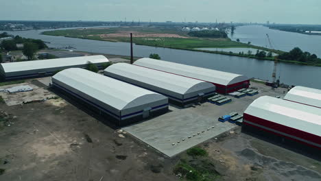 aerial clip of huge grain warehouses adjutant to a water channel