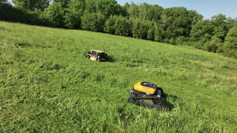 Drone-Shot-of-Robotic-Lawn-Mowers-Mowing-Grass-on-Sunny-Summer-Day,-Modern-Agriculture-Concept