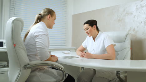 two cosmeticians talking in the office room