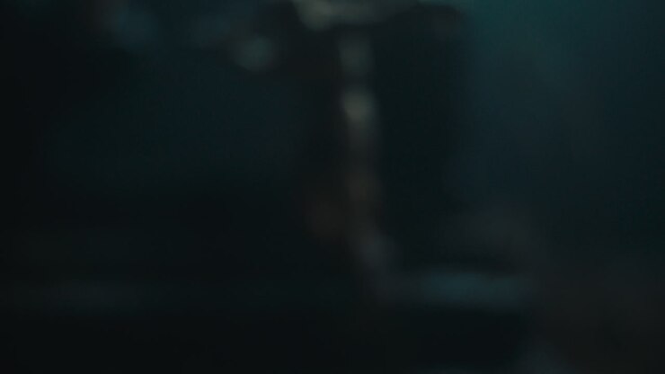 A miniature mummified doll hanging on the gallows at night