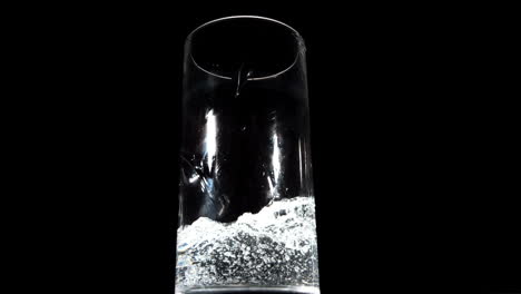 water being poured on black background