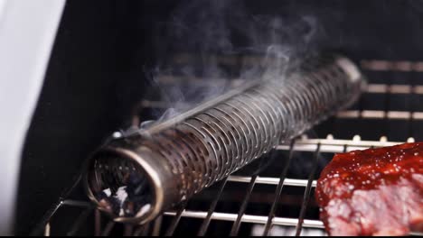 Close-up-of-the-smoker-and-smoke-edge-or-baby-back-pork-ribs-run-and-sauce