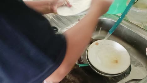 close up of housewife washing dishes