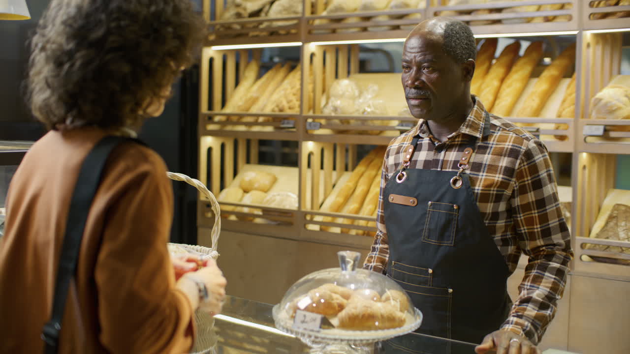 Customer interacting with bakery employee
