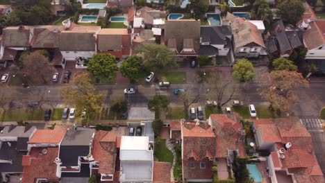 Cars-driving-along-Parana-Avenue-crossing-neighborhood-of-Vicente-Lopez-residential-area-in-Buenos-Aires,-Argentina