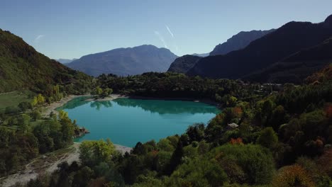 mountain blue water lake in italian alps dolomites with trees and peaks drone aerial