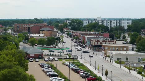 drone shot of lombard, illinois, capturing suburban streets, train tracks, and mixed residential and commercial buildings. crane down left zoom x2 cloudy day w
