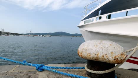 Close-up-ship-bow-hawser-rope-on-strong-mooring-bollard-Sozopol-port-marina