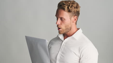 young businessman reading paper documents