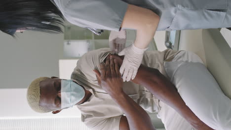 afro man getting vaccinated against covid-19