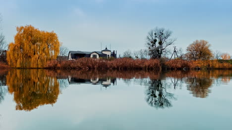 autumn lakeside house reflection