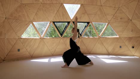 sun salutation pose, latina woman practicing yoga in a geometric outdoor studio, focusing on calm breathing and mindfulness