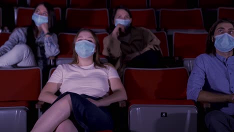 moviegoers wearing masks in theater