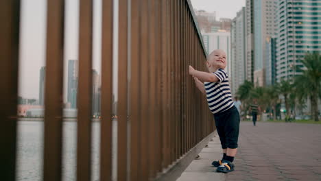 Happy-cute-babe-dancing-on-city-background-smiling-and-looking-at-camera