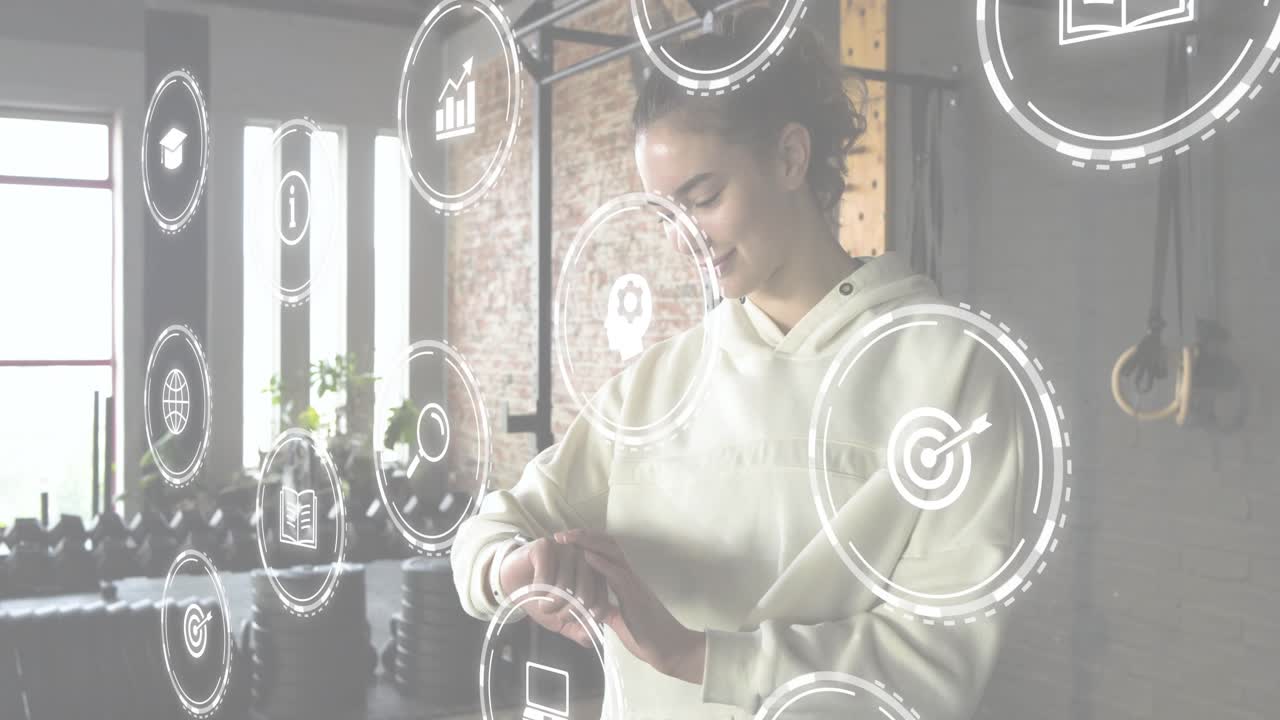 Vertical video: Looking down at wrist, woman tapping watch in gym confirming workout data, AR icons
