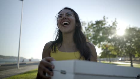 Happy-woman-holding-pizza-boxes