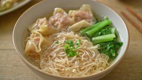 egg noodles with pork wonton soup or pork dumplings soup and vegetable - asian food style