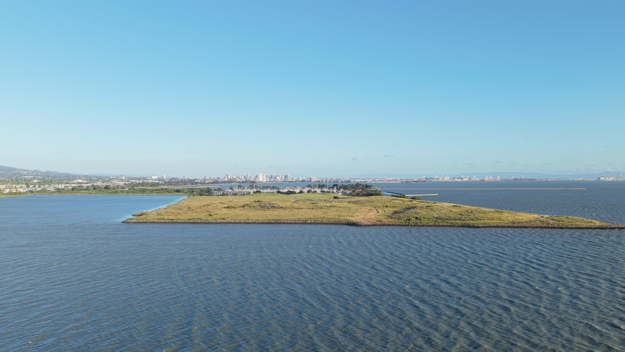Trails form delicate patterns across the park, captured from the air in quiet rhythm with the surrounding water.