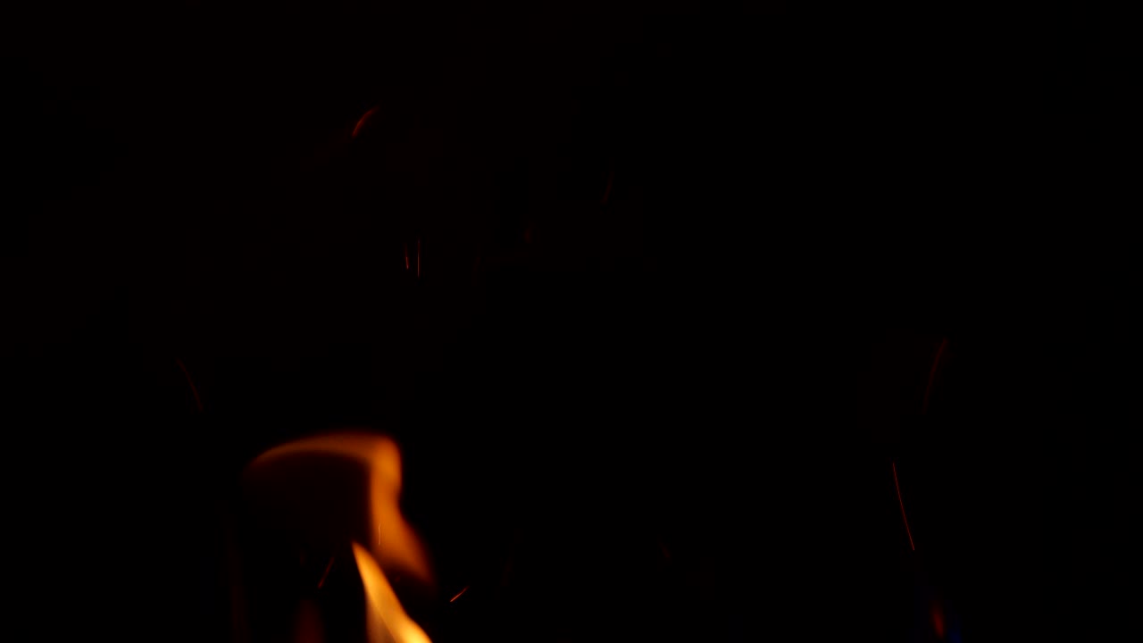 Sparkling, flying up sparkles for using in composition, vertical on black backdrop isolated. Screen mode for blending or transitions. Bright flames of fire on studio background, slow motion 50 fps 4k