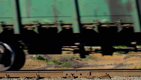 fast freight train passing through rural landscape