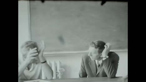 classroom scene, black and white video of people engaged in learning. circa ussr 1970: a captivating black and white video captures soviet people actively participating in a classroom setting.