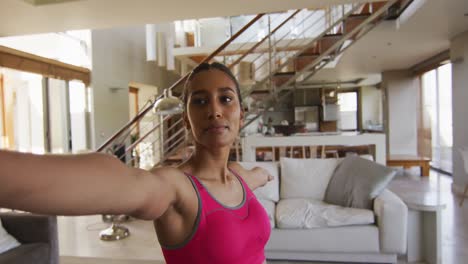 Portrait-of-a-mixed-race-woman-practising-yoga-at-home