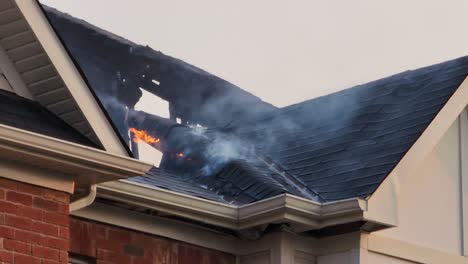 roof of residential houses burning in neighborhood in toronto, canada