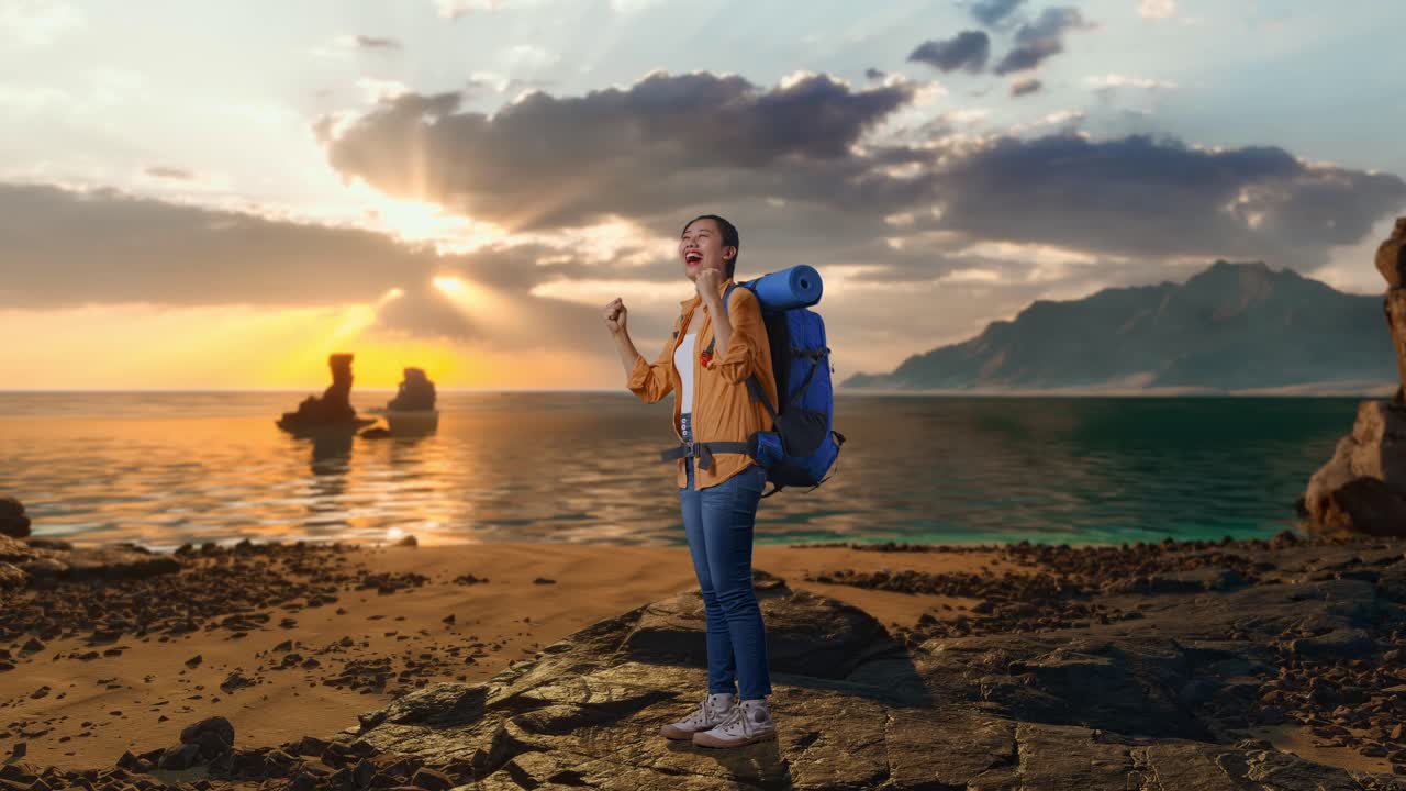 Full Body Side View Of Asian Female Hiker With Mountaineering Backpack Screaming Goal Celebrating The Success While Standing on Beach During Sunset Time