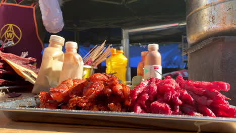 vendor selling meat on the street with pots