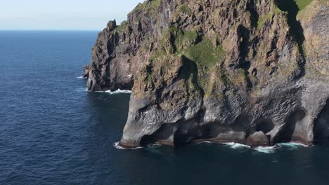 elephant rock on wild volcanic island in iceland, aerial
