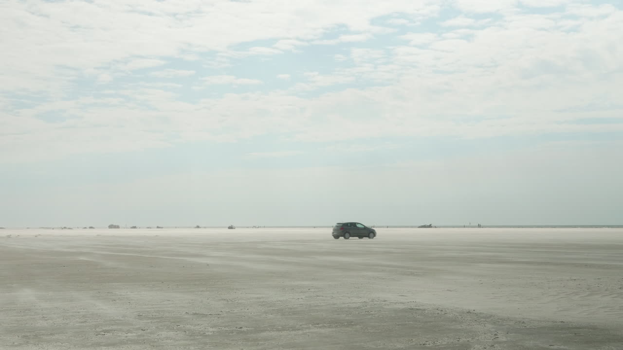 Lonely Car Driving on a Large Beach in Fan&oslash;, Esbjerg, Denmark, Grey VW Polo