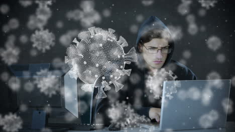 Animation of of macro covid19 cells over man wearing hoodie, using a laptop