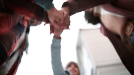 a group of people joining hands in unity and support