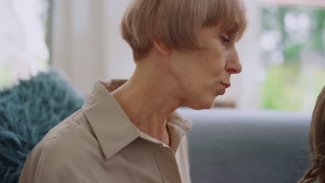 grandmother talking with granddaughter at home. family spending time together