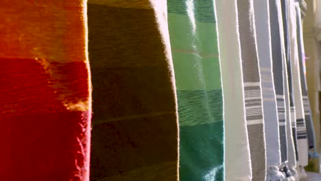 colourful fabrics hanging from wall cu