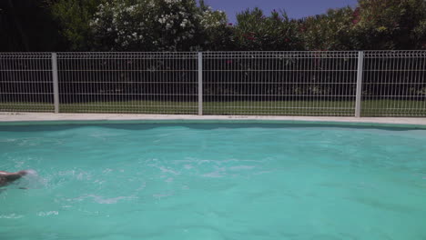 woman swimming crawl style in outdoor swimming pool