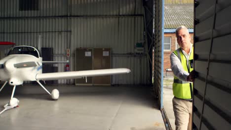 crew member opening the door of hangar 4k