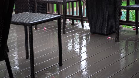 light rainfall on a deck during a light summer storm
